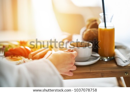 Breakfast in bed, cozy hotel room. concept Royalty-Free Stock Photo #1037078758
