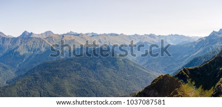 Scenic mountainous area against blue sky with clouds