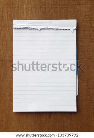 tear paper note on wood texture background