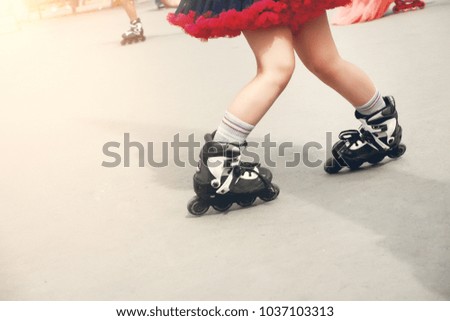 Legs of person on inline rollerblades. Kid's legs.