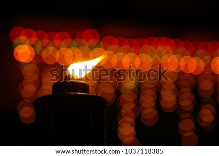 A traditional kerosene lamp, also known as pelita with light bokeh as background.
Eidul fitri concept. Image contains grain and soft focus.