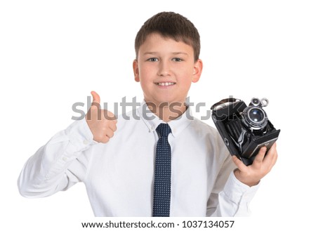 The teenager the photographer with the camera in a hand and a thumb top on the white isolated white background.