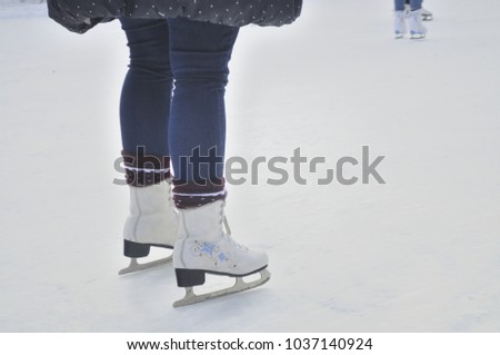 Skater legs at skating rink.