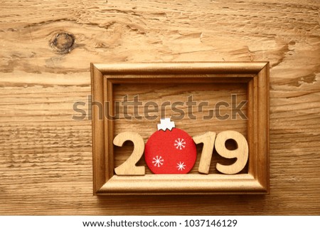 2019 happy new year.wooden calendar with picture frame on wooden table background. round circle christmas toy 