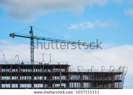 Construction site with cranes on sky background Royalty-Free Stock Photo #1037155111
