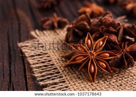 anise stars on a dark rustic background Royalty-Free Stock Photo #1037178643