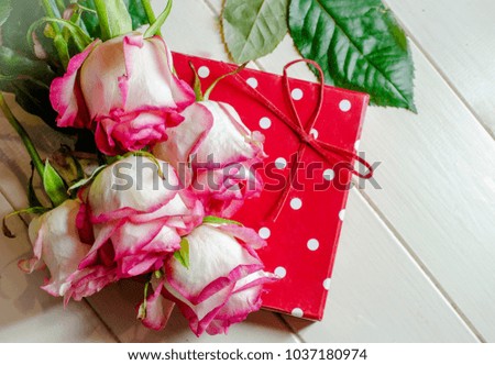 flowers roses and a gift for a girl