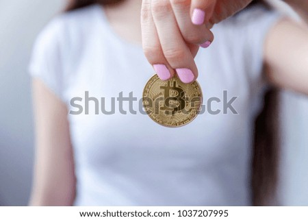 Cryptocurrency golden bitcoin coin in woman hand. Electronic virtual money for web banking and international network payment. Symbol of crypto currency