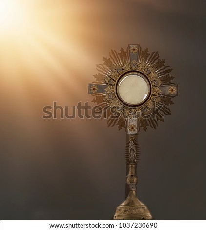 an image of a golden mostrance with sun light Royalty-Free Stock Photo #1037230690
