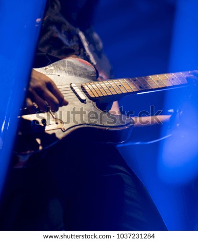 detail of vintage electric guitar maple fingerboard on dark background. Selective focus.
