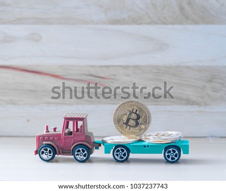 Cryptocurrency coin in white toy car on wooden table background, image gold coins on pattern wooden,