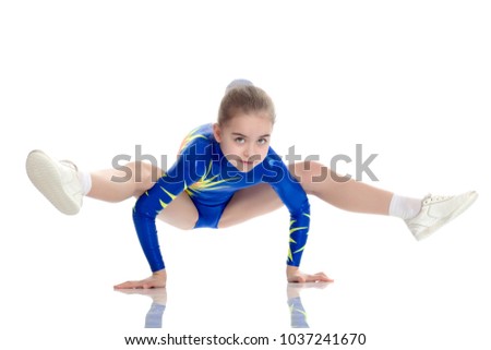 A charming gymnast girl, a younger school age, in a beautiful blue swimsuit, performs an exercise on the floor.She makes a stand on her hands, and performs a twine.Isolated on white background.