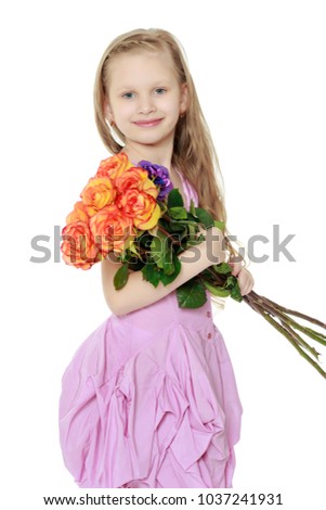 Happy little blond girl, with long curly hair, in a beautiful pink dress above the knees.With a large bouquet of tea roses.Isolated on white background.