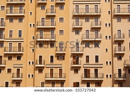 Interesting photo of building facade with windows, doors and balconies