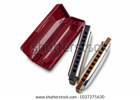 harmonicas , french harmonica or mouth organs . blues harp and Plastic box on white background.Isolated