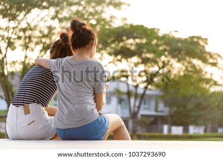 A couple girl has love and looking together with sunset time at garden park and river in the evening.