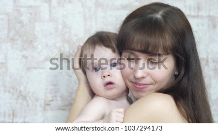 mother plays with little child, happy family