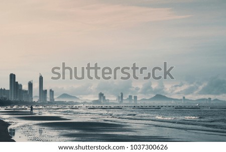 Building, mountains, beach, sea and cloud view on the sunset.