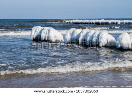 Baltic Sea in Poland. Sea shore and falachron with icy wooden pegs. Season winter.