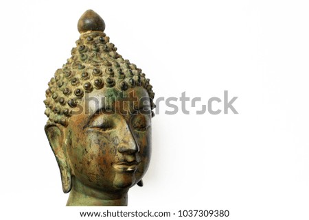 Head of buddha statue, close up on isolated white background. Soft focus.