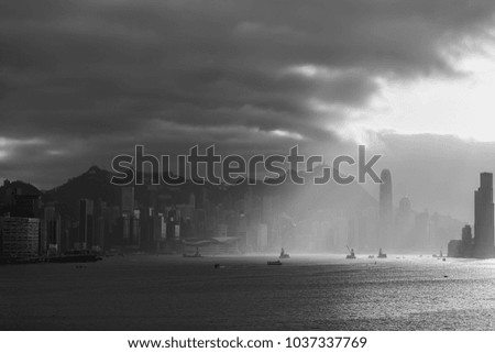 black and white picture Cityscape and skyline at Victoria Harbour in Hong Kong city at The sun is setting