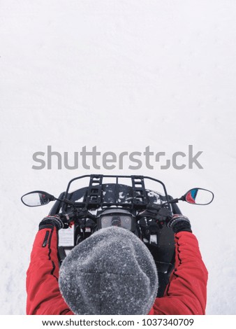 Man in atv quad bike. Winter snow field.