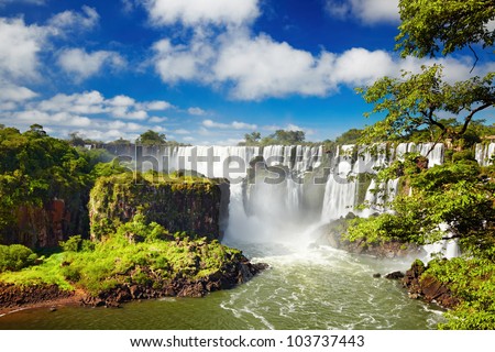 Iguassu Falls, the largest series of waterfalls of the world, located at the Brazilian and Argentinian border, View from Argentinian side Royalty-Free Stock Photo #103737443