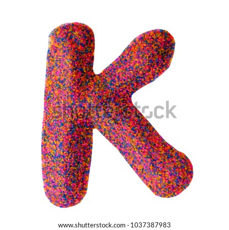 Beautiful Alphabet K, made by multi color sand, isolated on white background