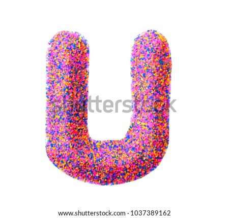 Beautiful Alphabet U, made by multi color sand, isolated on white background