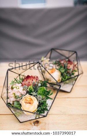 Little florariums with fresh bouquet stands on the table. Decor. Reception