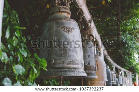 ritual Buddhist bells in the tourist places of Asia close-up. Buddhism in Thailand