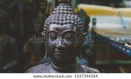 old Buddha statues on the local market close-up. Buddha as a symbol of Buddhism in Thailand and Asia. Portrait of a buddha in statue format on the local market
