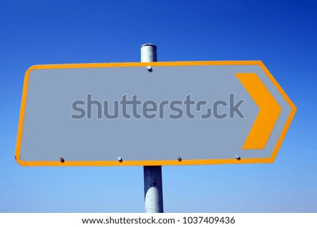 Road sign with empty space and blue sky in the background.