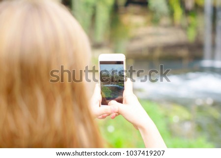little girl making photo on smartphone in travel