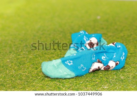blue socks cartoon pattern on yellow grass background 