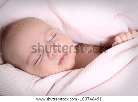 The baby sleeps on a light background