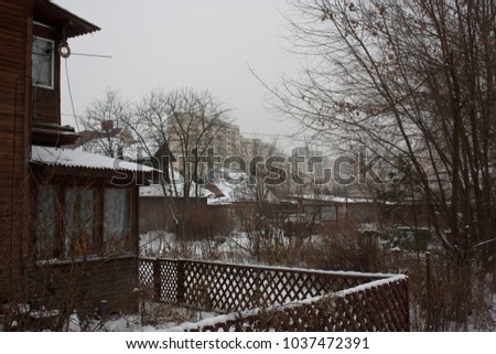 Distressed house with building on the background.