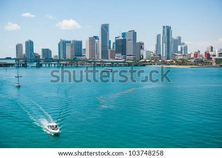 Scenic view of Miami city skyline with boats sailing in sea in foreground, Florida, U.S.A.