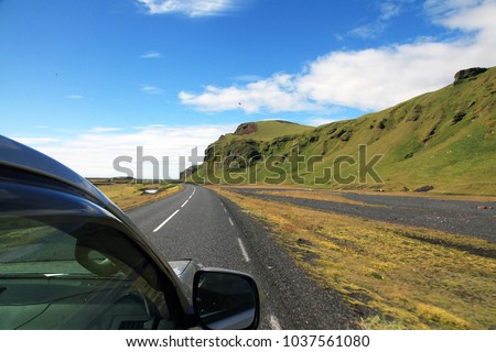 View from the car to Icelandic road and mountains Royalty-Free Stock Photo #1037561080