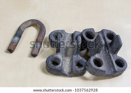 Old garden accessories. Rusty hose clamps on the workshop table. Light background.
