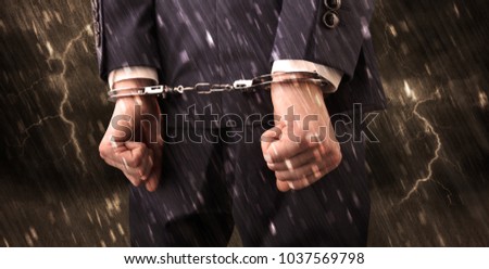 Stormy bad day concept with close handcuffed elegant man
