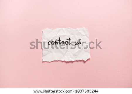 Contact us - paper with words on pink background