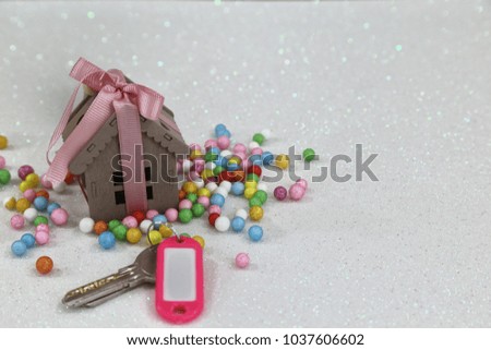 Real estate concept. Little wooden house  on the white background  with key 