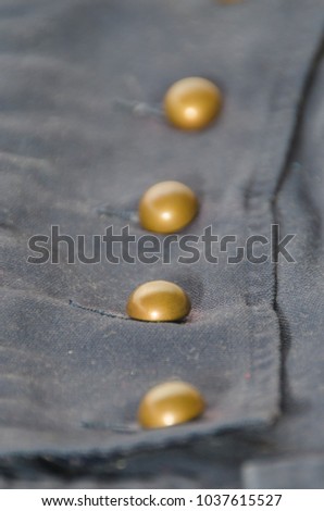 texture, dark blue fabric with brass buttons, cages, background