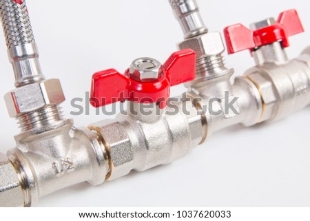 Plumbing gate ball vales, flexible water hose and fittings on a white background