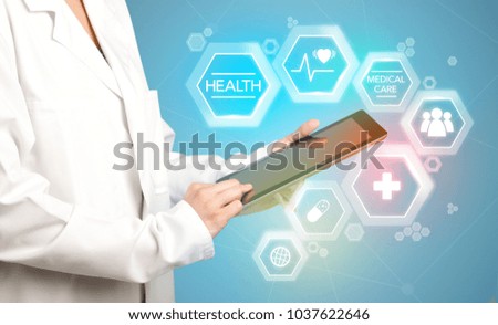 Female doctor holding tablet with blue background and heart related charts 