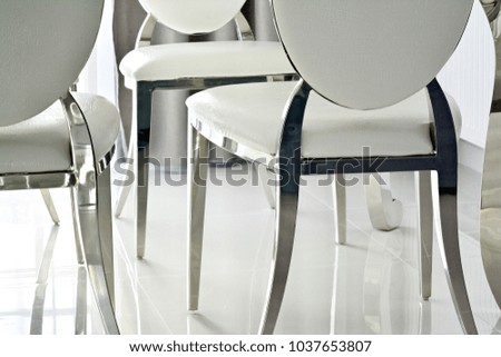 Glass table and white modern chairs in dining room interior