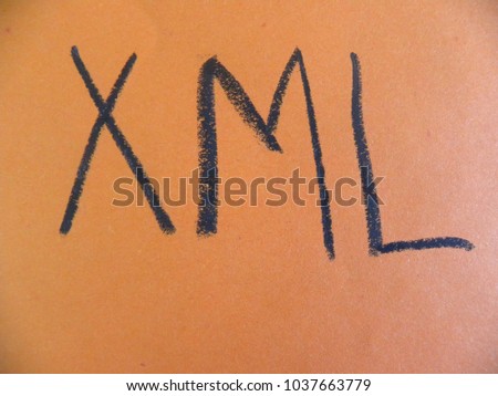 Text XML hand written by black oil pastel on orange color paper