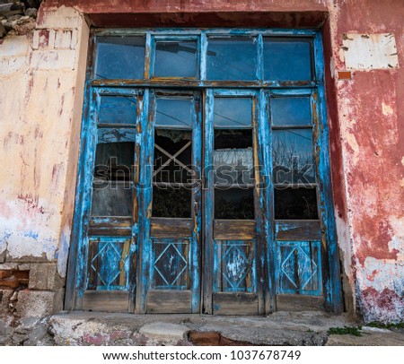 Weathred blue wooden door at abandoned house, Tire, Izmir