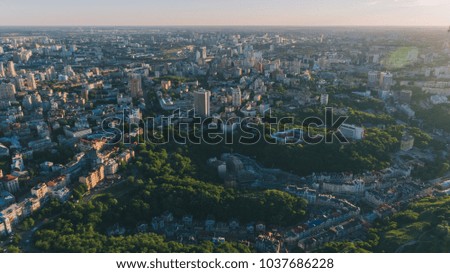 Aerial view of the city. Panorama. Many buildings. Glare of the sun. The hem. Horizon. The sun shines on the trees. Day. Summer. Kyiv. Nature. Ukraine.